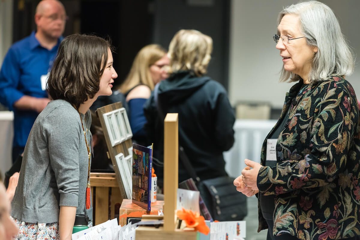 Attendee and sponsor chatting during a career fair