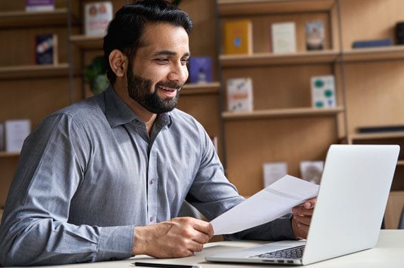 Official looking man presenting paper over online meeting