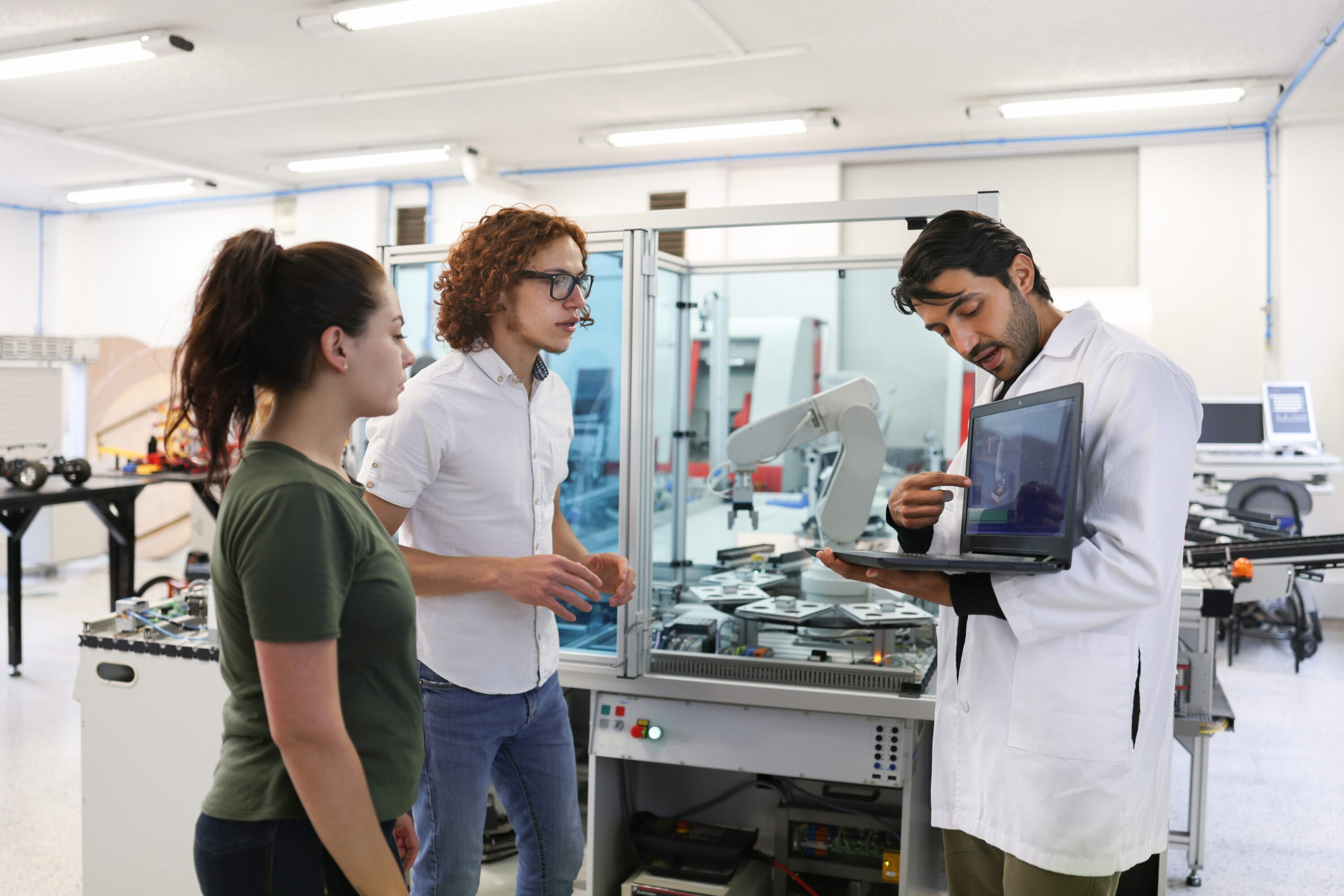 Two engineers and a scientist reviewing code.
