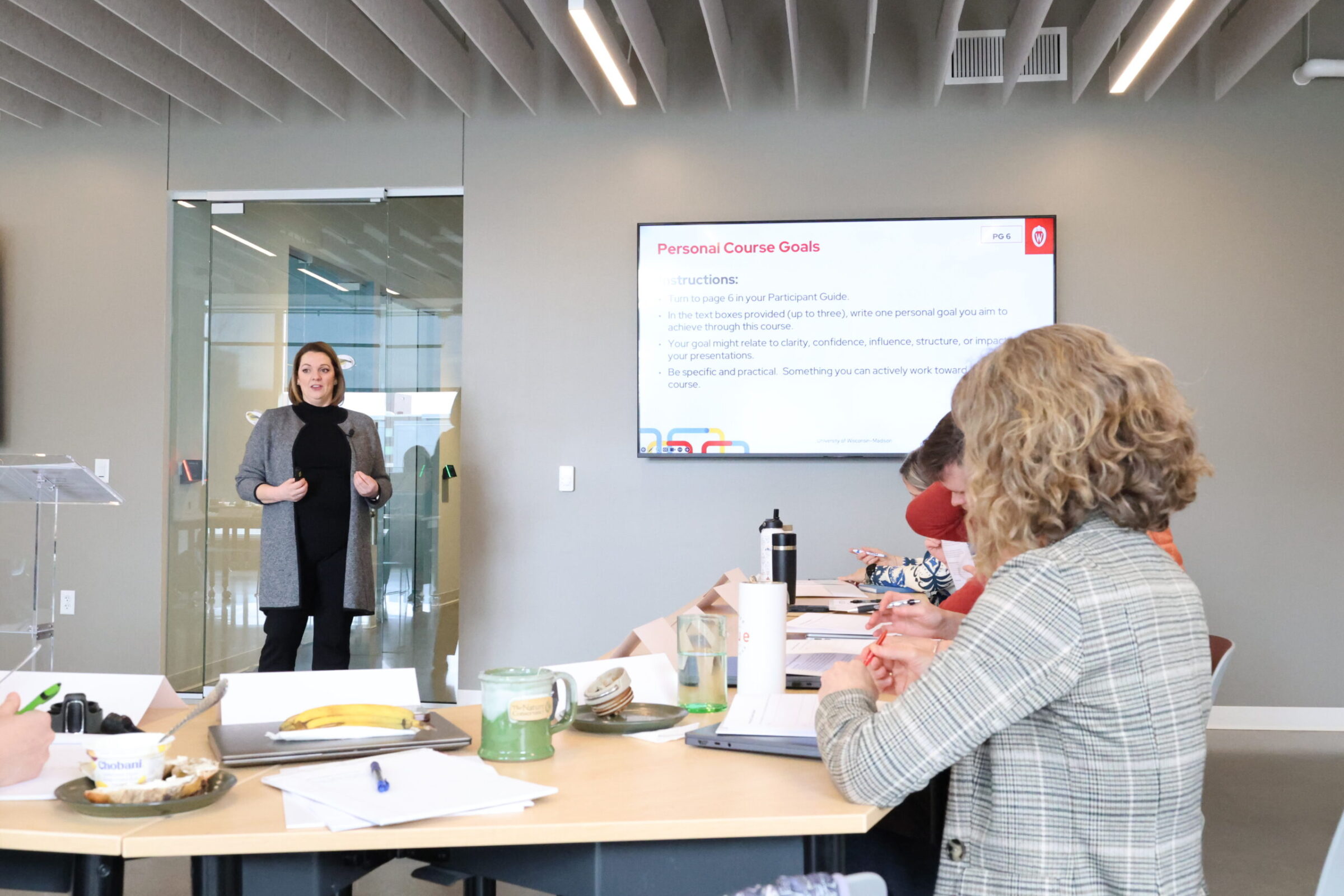 A group of people listening to a presentation
