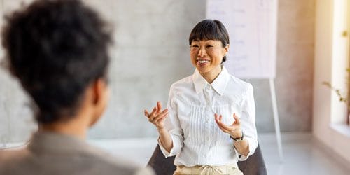 A woman speaking with a man.