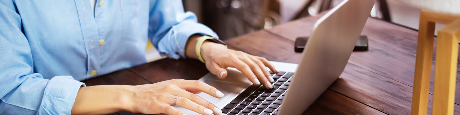 A pair of hands on a laptop keyboard