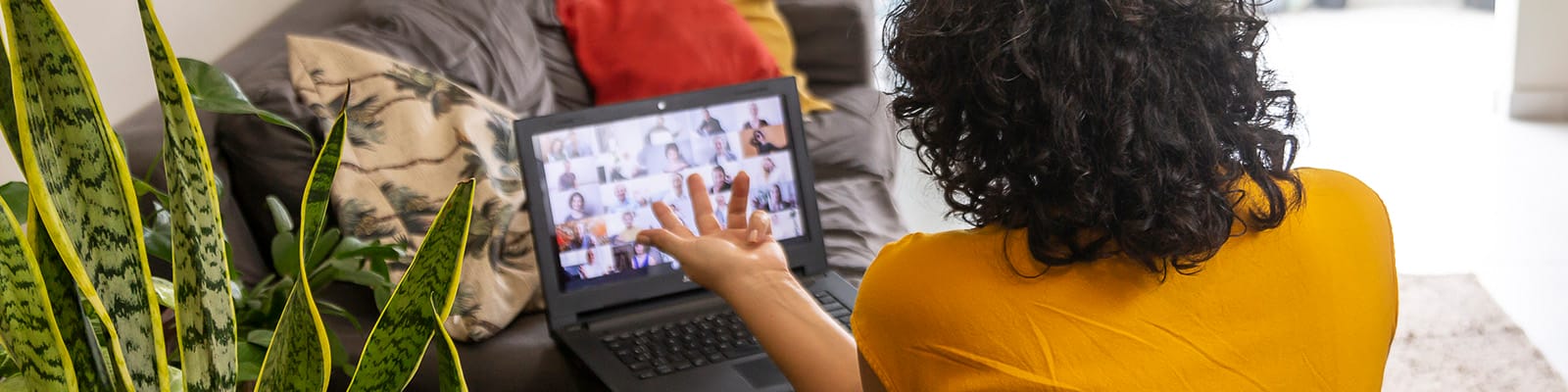 A view of a woman in an online meeting.